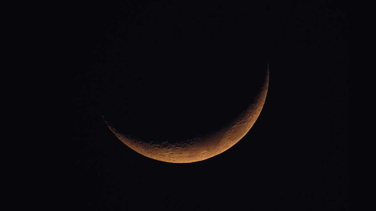 New Moon with orange glow