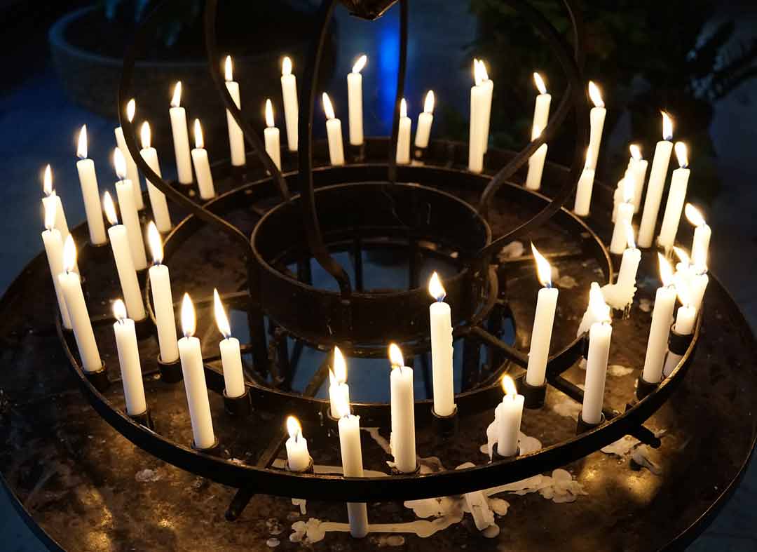 circle of candles lit in the darkness