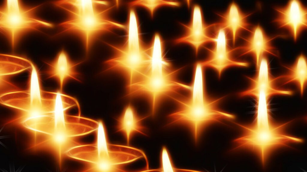 Chicago Reiki - Holy Fire® - Image of several candles burning in the darkness