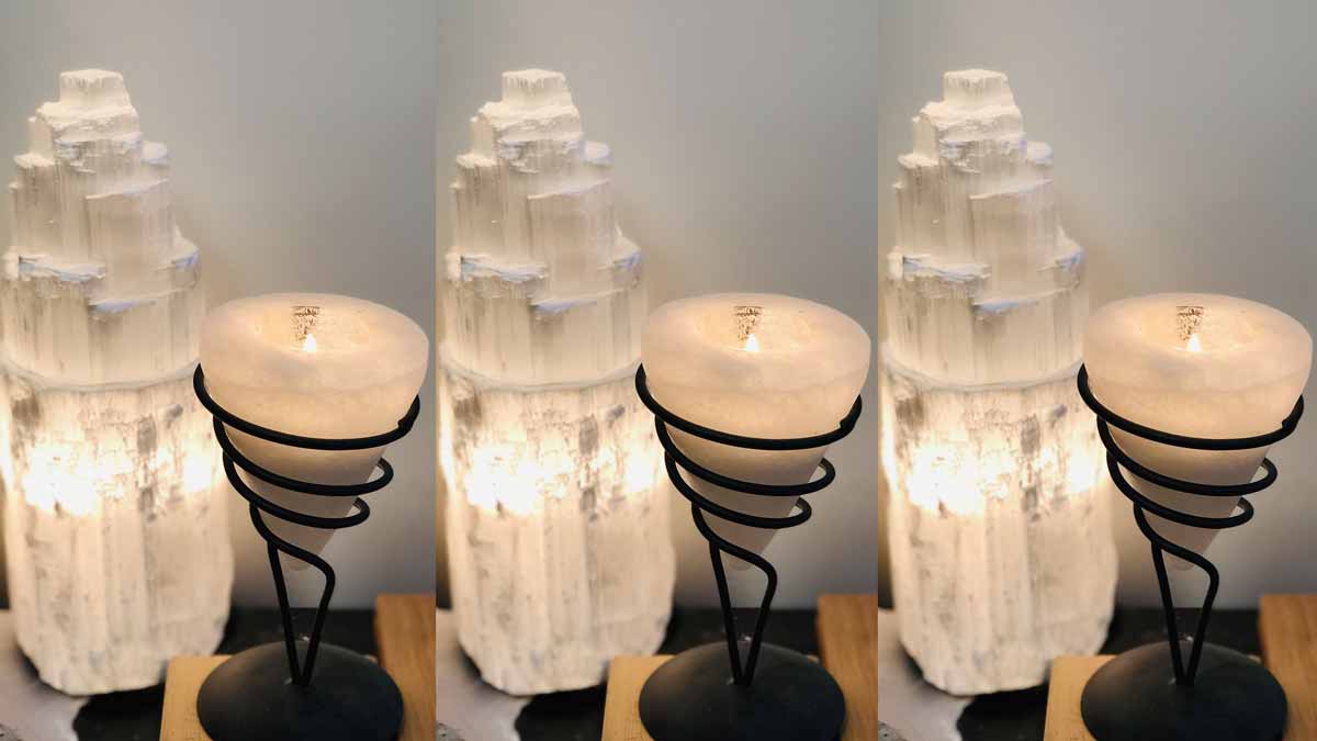 Jerry Mikutis Chicago Reiki and Crystals - Selenite - selenite tower next to a cone shaped selenite candle