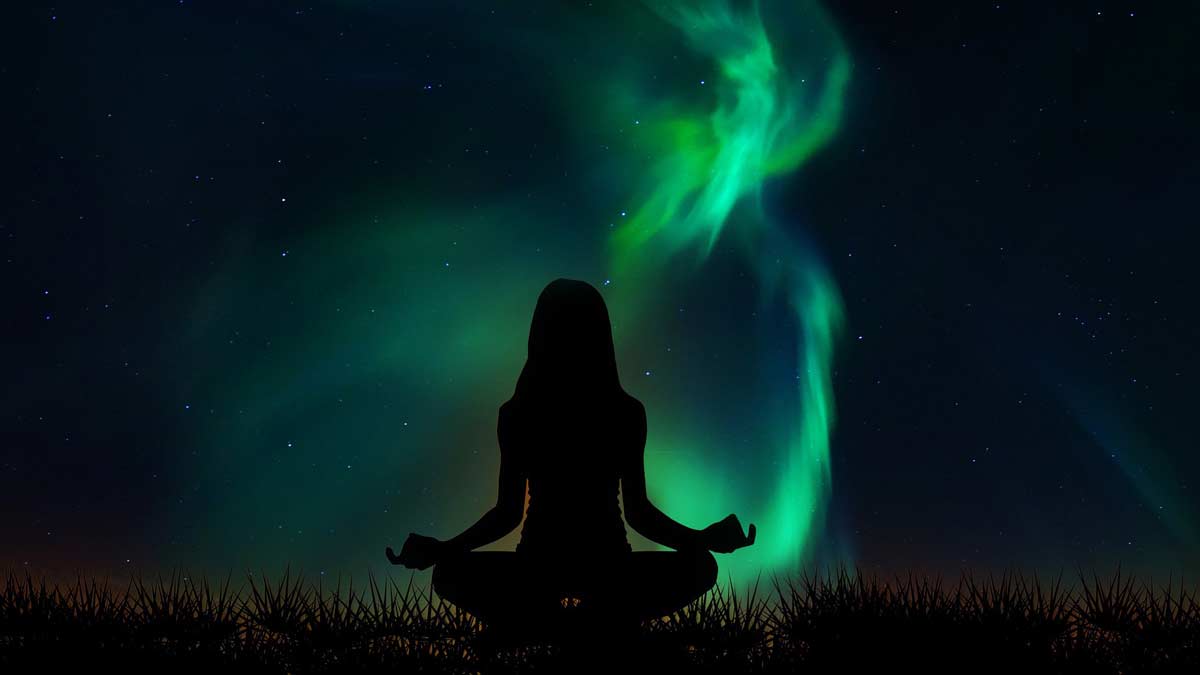 Jerry Mikutis - Reiki and Gentle Yoga - Woman sitting in lotus with aurora borealis behind her